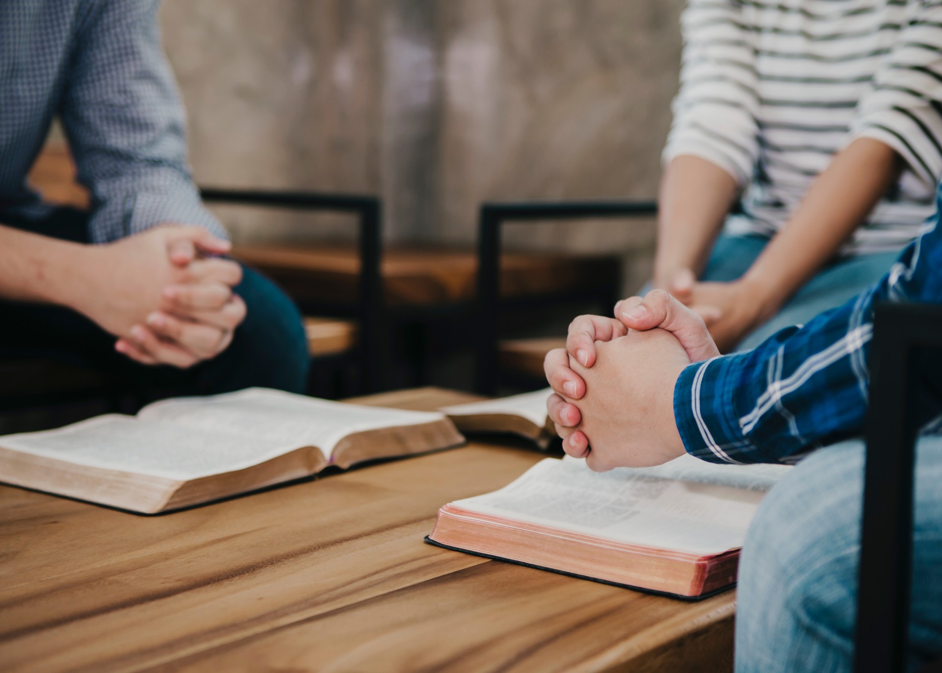 group of christian sitting around wooden table group of christian sitting around wooden table